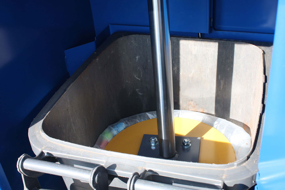 compacting waste into a 240 LTR wheelie bin